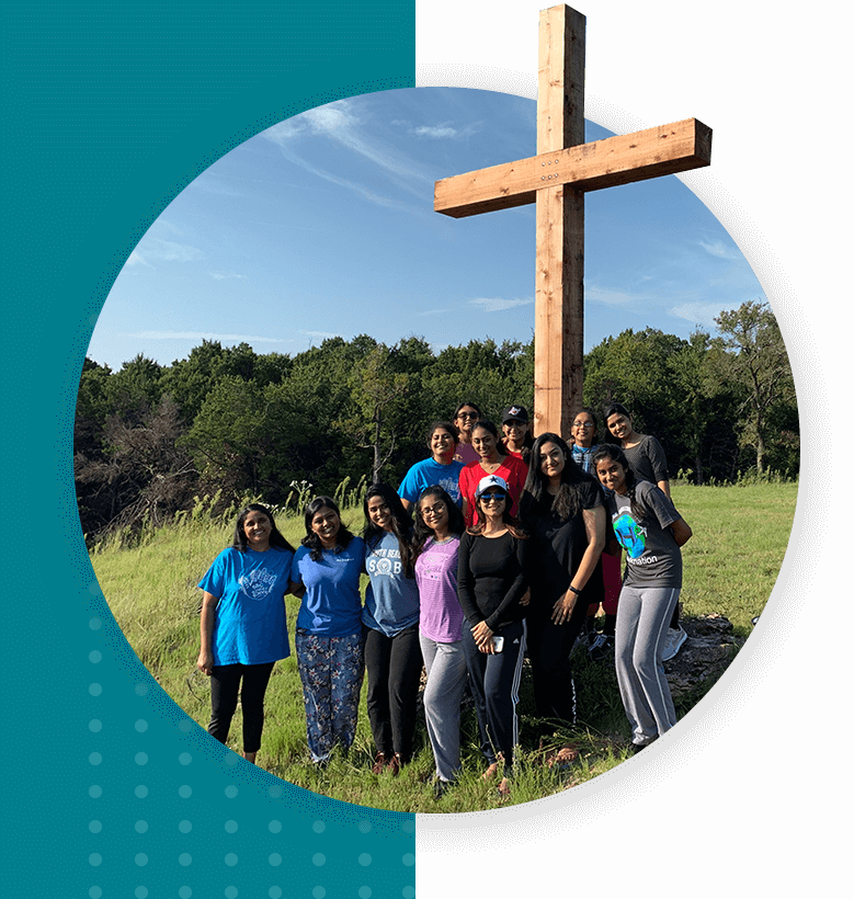 Group of young people standing at the Christ cross and posing for a photo