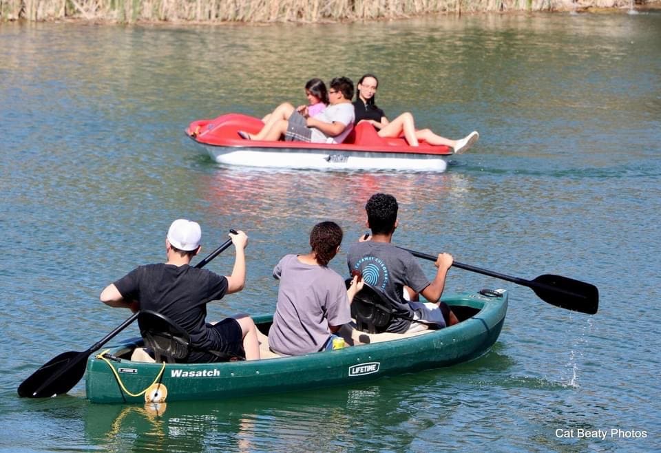 A group of people in a canoe on the water.