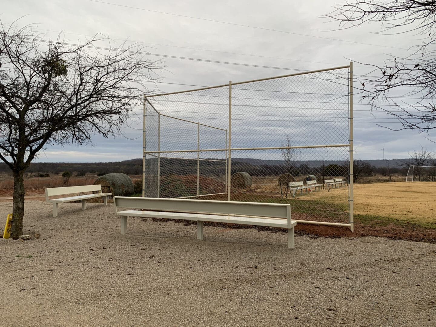 A bench in the middle of an empty field.