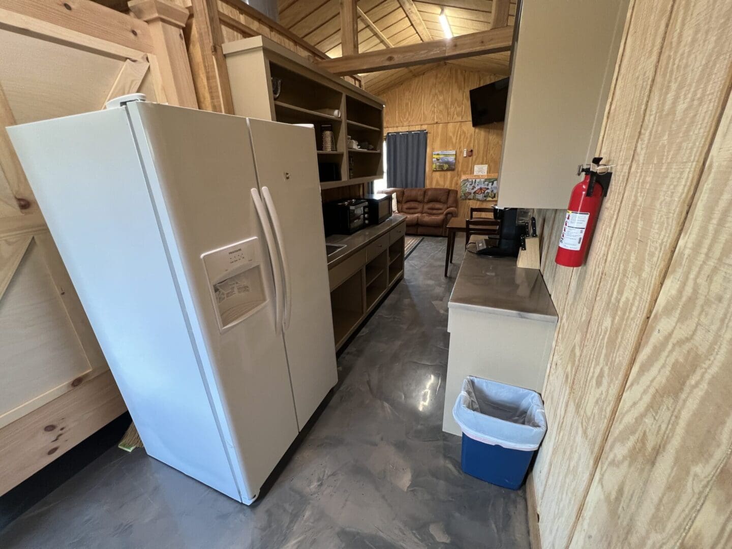 A fridge and kitchen counter top in the field house kitchen