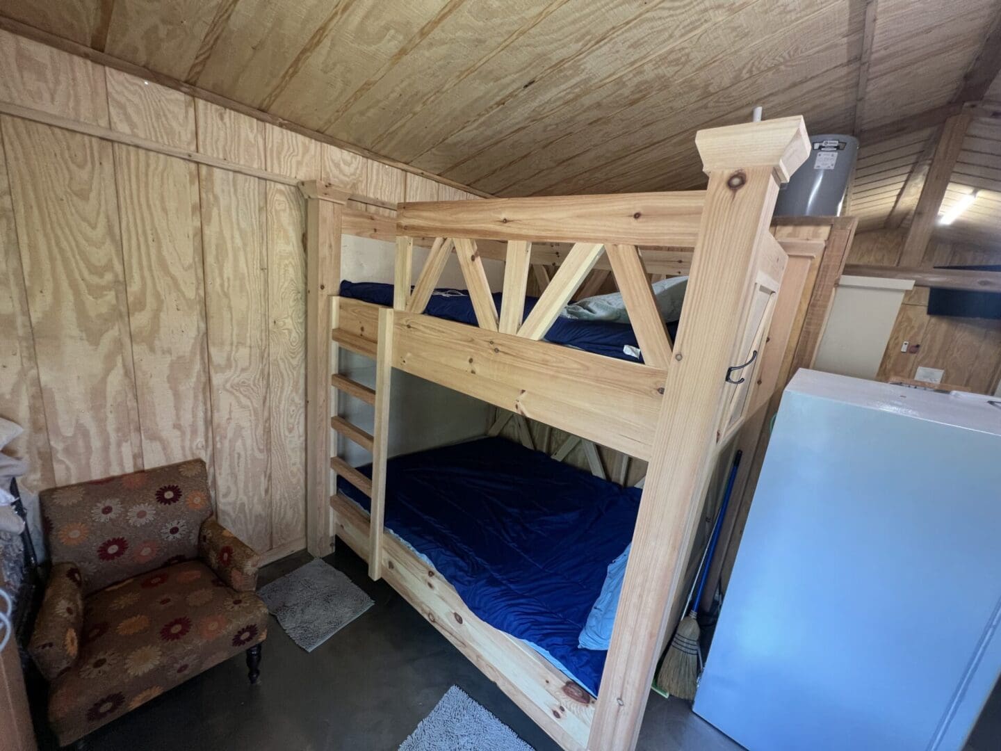 A wooden house with the queen bunk beds