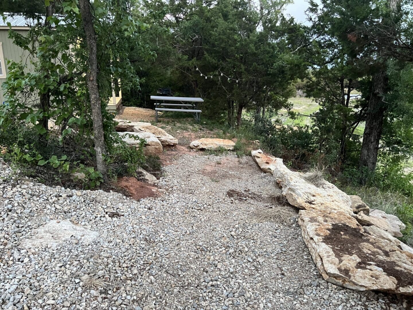 A bench sitting on top of a gravel path.