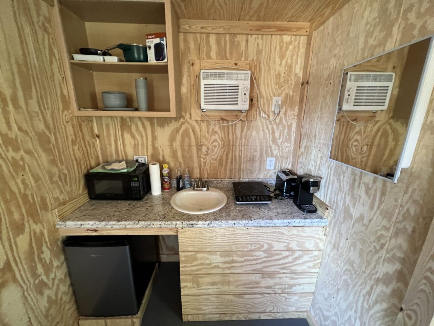 A small kitchen with a sink and microwave.