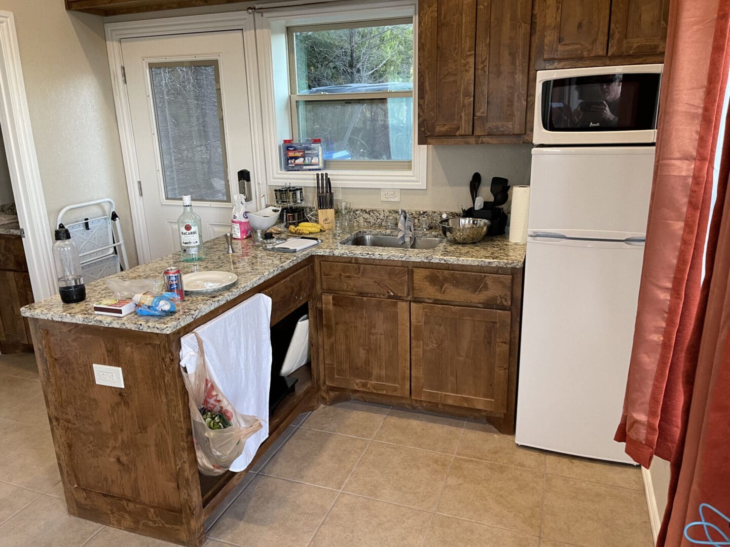 A kitchen with brown cabinets and white appliances.