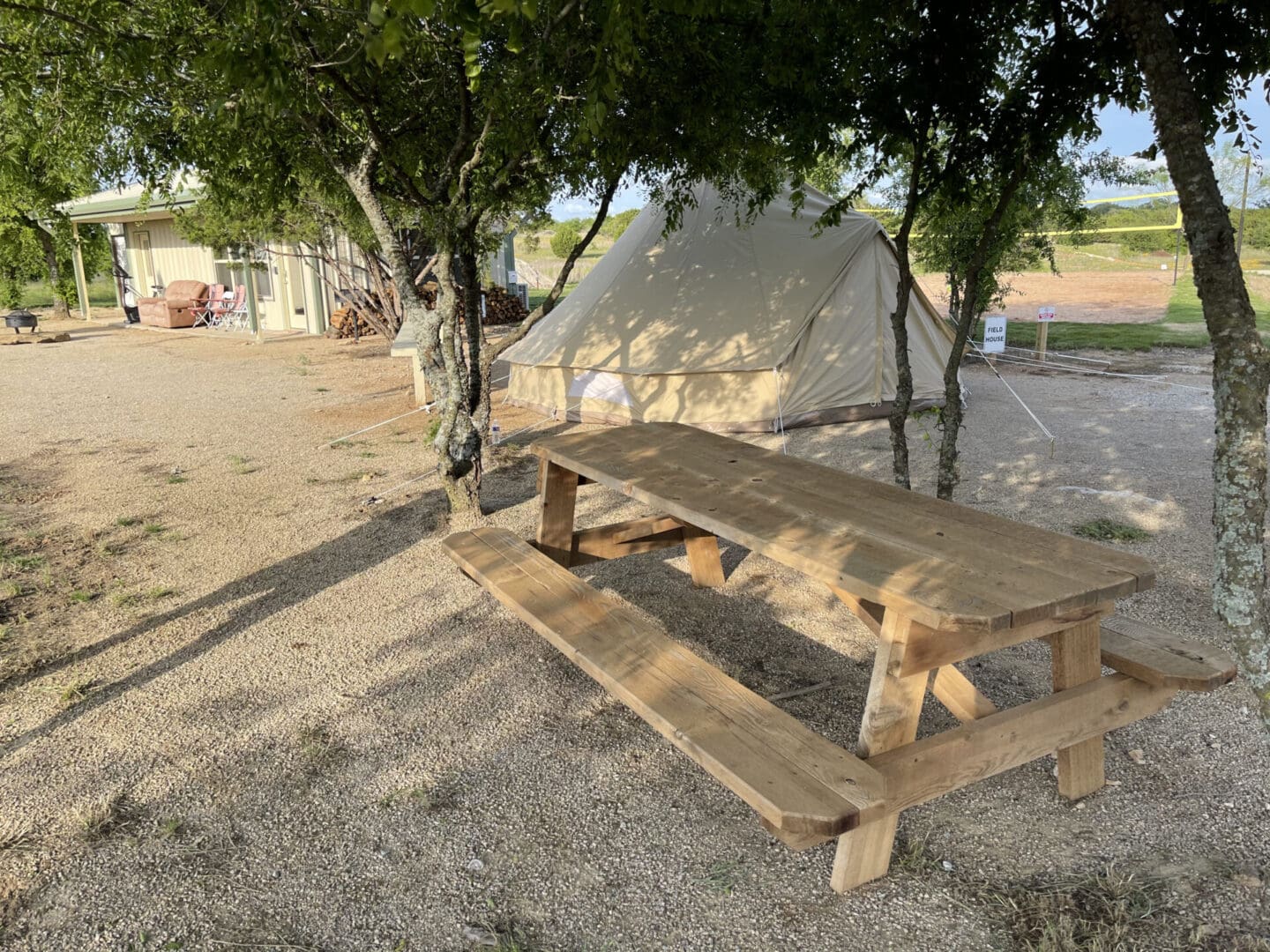 A wooden picnic table near the tent