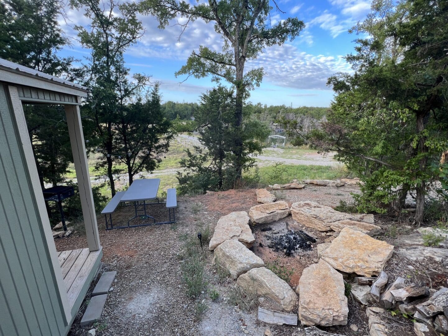 A stone fire pit area and the the picnic table outdoor