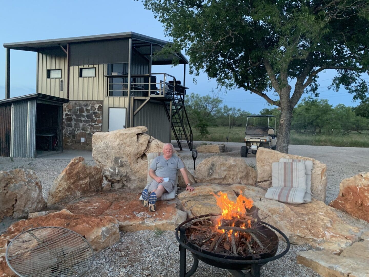 Old Man Sitting Peacefully Near A Fire Pit