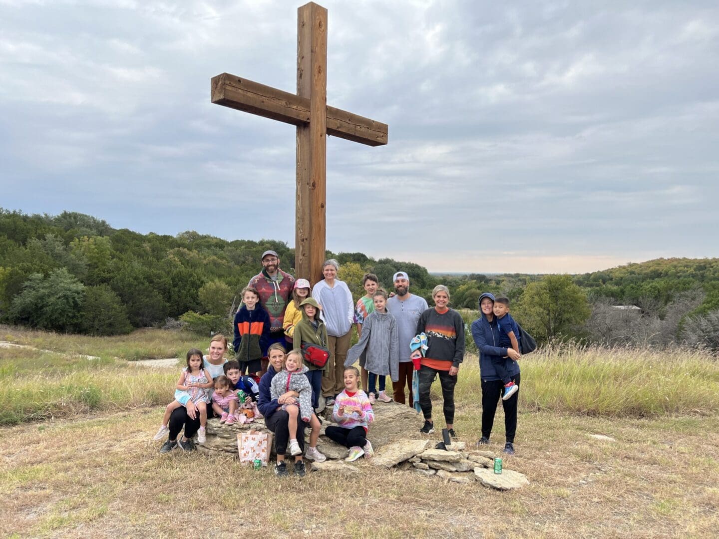 A group of people standing around a cross.
